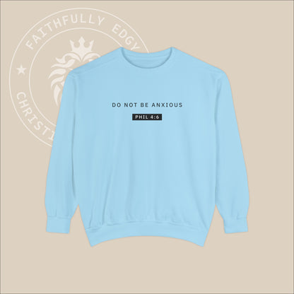 Light blue crewneck sweater with black "Do not be anxious" print. 