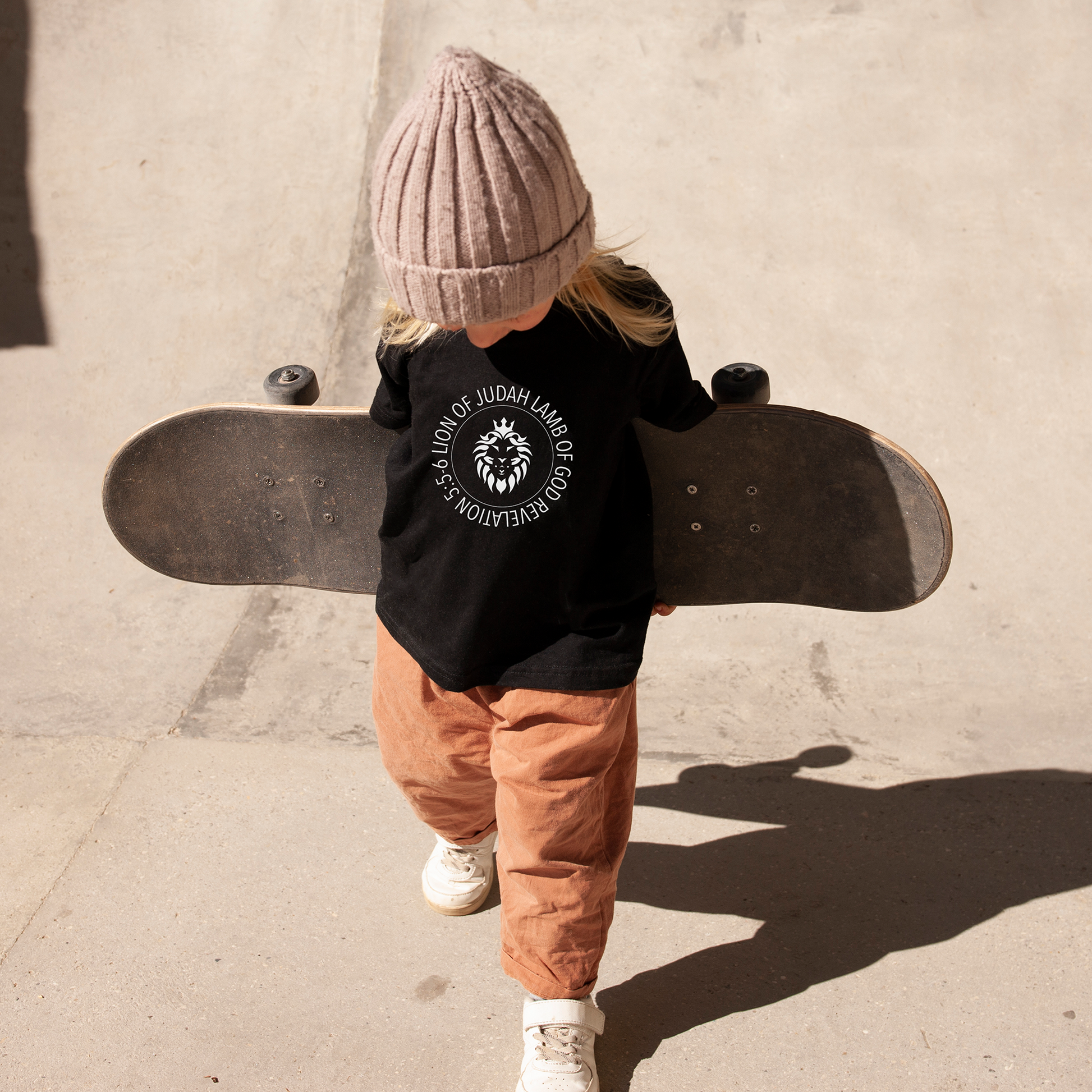 Black toddler tee with white "Lion of Judah Lamb of God" print.