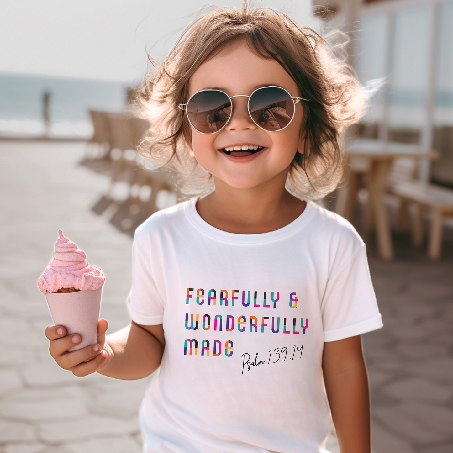 White toddler tee with rainbow colored "Fearfully & Wonderfully Made" print. 